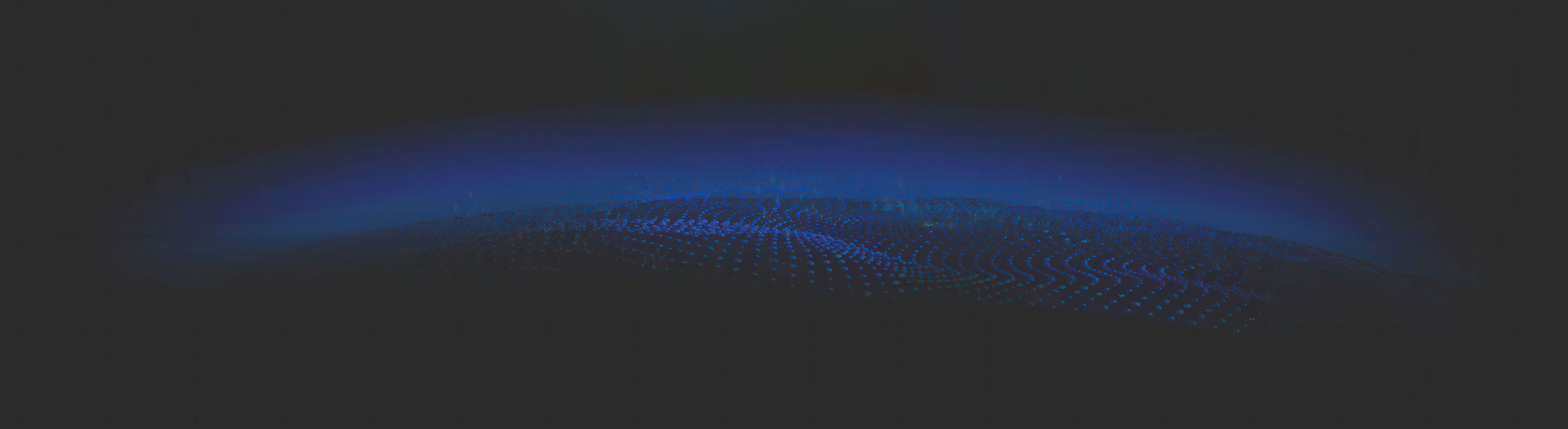 A slightly curved blue line on a black background represents a digital globe of the Earth, with subtle blue lights indicating data layers resting on top