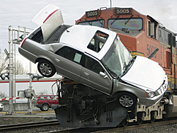 photo of a train colliding with a car