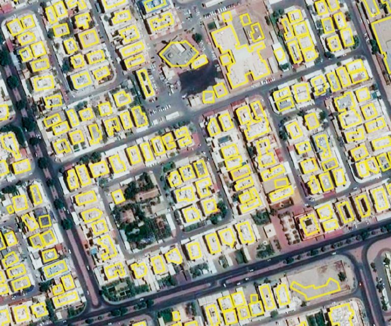 Satellite imagery of a neighborhood in Kuwait City with all the buildings outlined in yellow