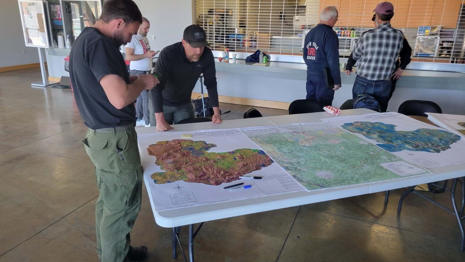 Fire managers examine maps to determine the areas for PODs