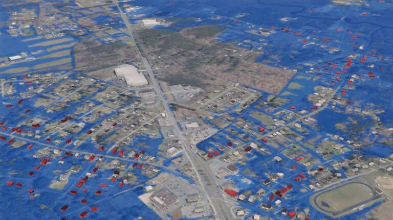 An aerial 3D map of Crisfield that shows floodwaters in blue, affected structures in red, and unaffected structures in gray