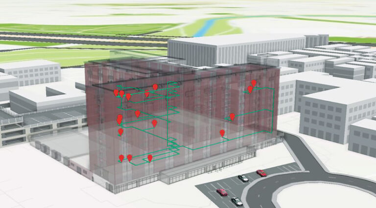 A computerized image of a tall, T-shaped building and parking lot, with shorter office-style buildings in the background. The T-shaped building is a darker color than the others and has about 15 red dots scattered across the wall facing the parking lot.