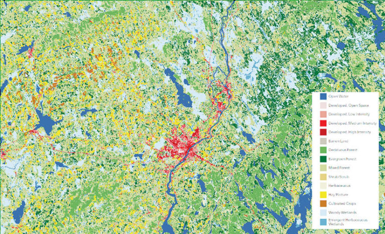 A land-cover map that shows various types of forest in different shades of green, water and wetlands in two shades of blue, developed land in red, cultivated crops in brown, and pastureland in yellow