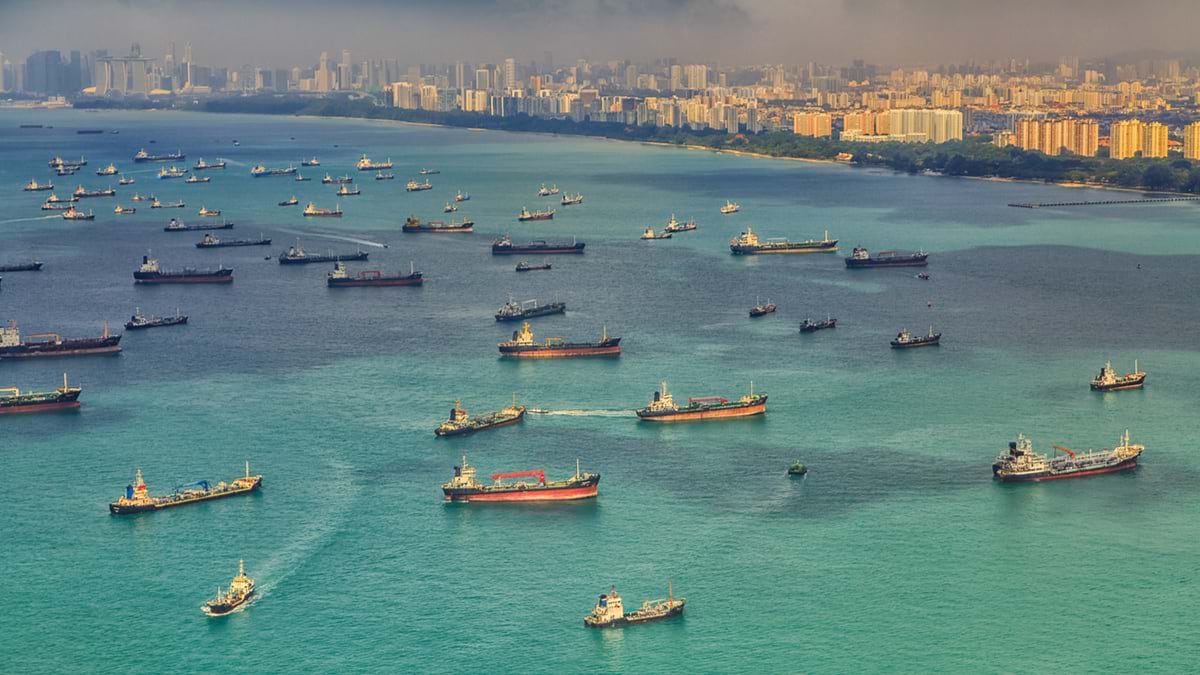 Ships sit in Singapore's harbor waiting to be loaded and unloaded