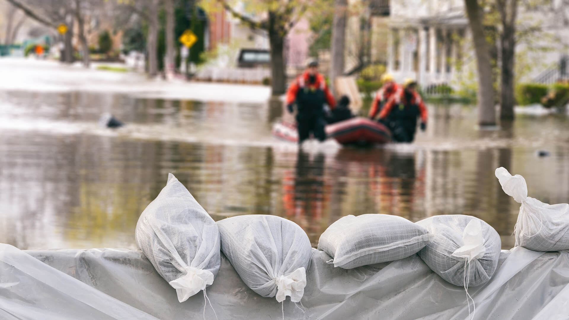 Sandbags holding back a flood represent the insurance industry and its ability to backstop consumers