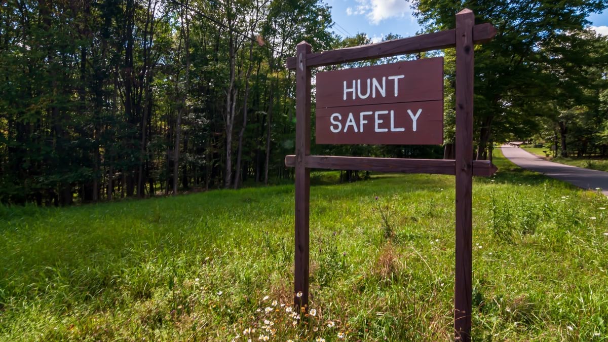 A wooden sign saying HUNT SAFELY in Warren County, Pennsylvania