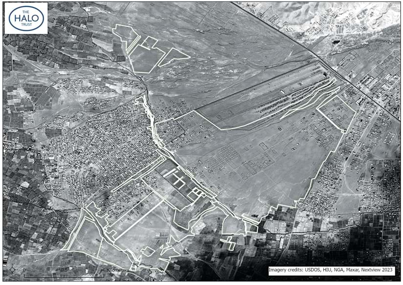 A grayscale aerial image of land that shows largely undeveloped areas surrounded by white polygons, plus developed areas, and other plots of land