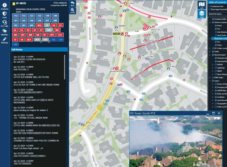 A map of a neighborhood with red lines on one street and drawn across a few houses and points of interest marked in red, plus a list of incident calls to the left of the map showing updated information about a fire, and a video image of smoke rising out of a residential neighborhood