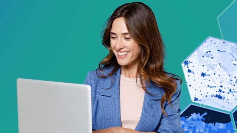 A person smiles at a laptop