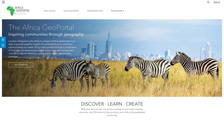 The Africa GeoPortal homepage showing three zebras grazing in tall, dry grass with the skyline of a modern city rising in the background against a blue sky.