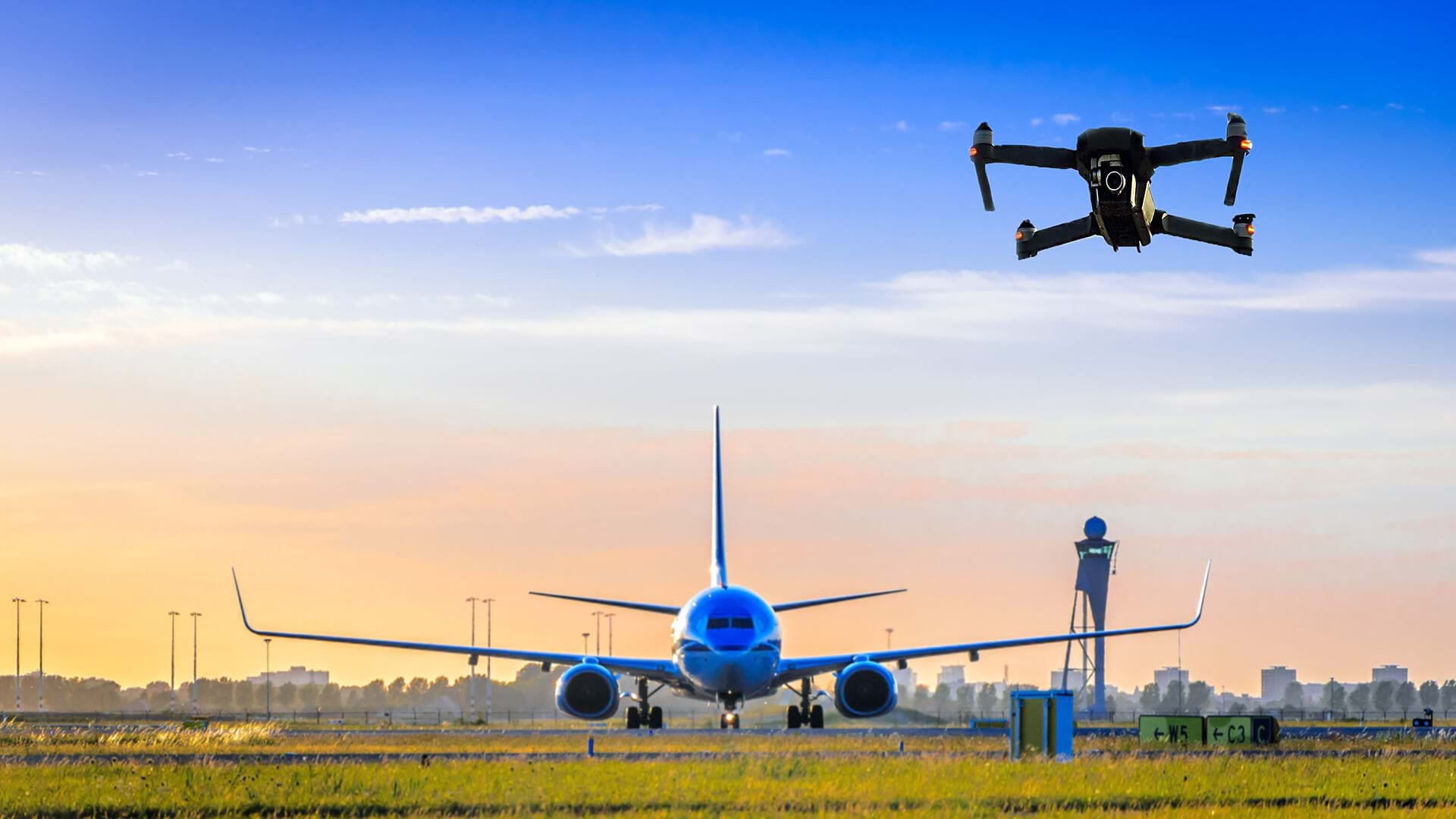 Drone inspections at an airport, with a commercial airplane in the background