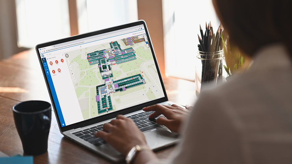 A person working on a laptop and using ArcGIS Indoors.