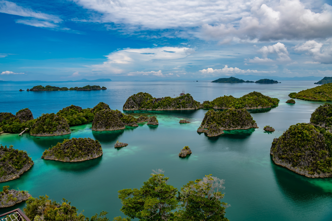 Teal blue sea with clusters of islands on an island in Indonesia