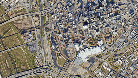 An aerial view of a highway and a developed urban area