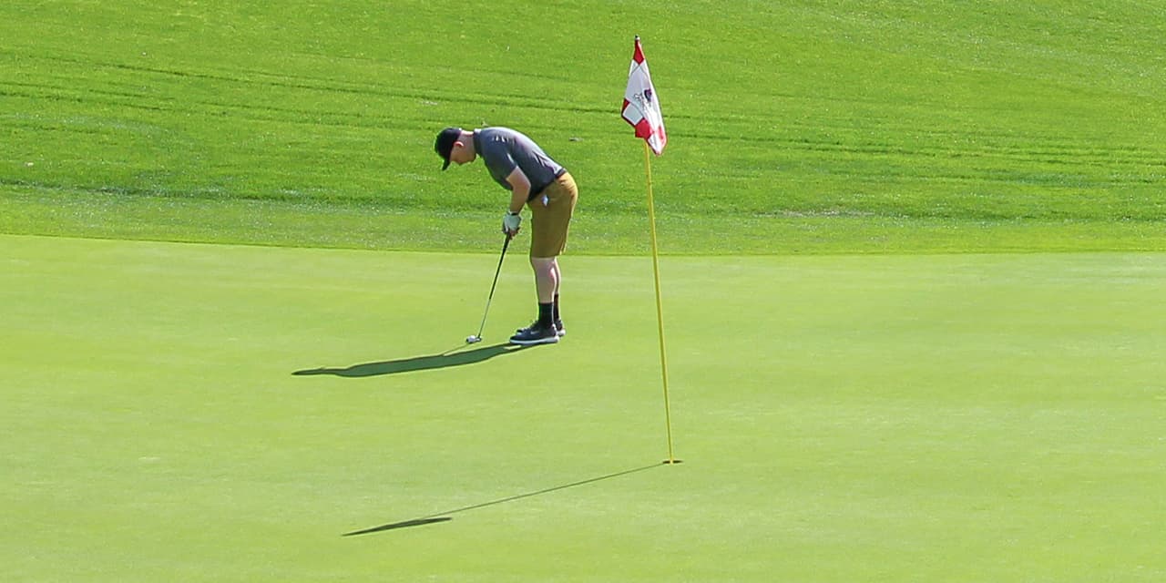 Golfer on the green preparing to putt