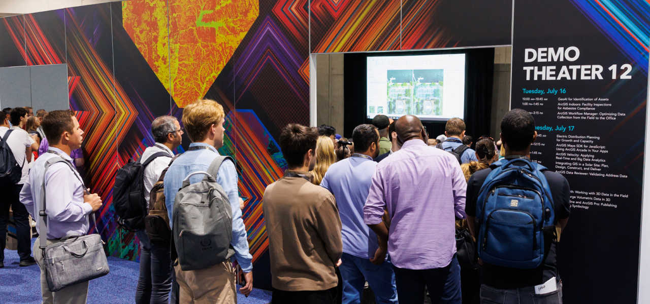 Event attendees gathered outside of Demo Theater 12 during a presentation to a full audience