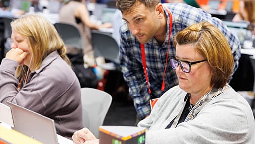 Esri employee assisting an attendee on a computer in the Hands-On Learning Lab