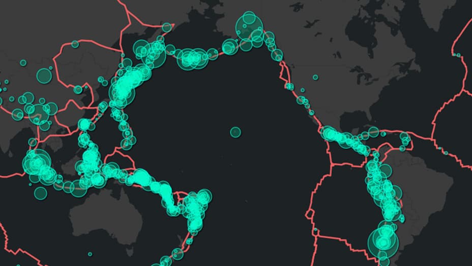 Black and gray basemap with fault lines drawn in red and bright teal circles indicating seismic activity and magnitude