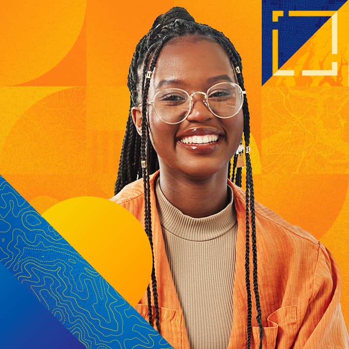 Person with long cornrowed hair round glasses, and a yellow jacket smiles broadly against a yellow and blue abstract background