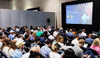 Audience seated in a Demo Theater watching a presentation