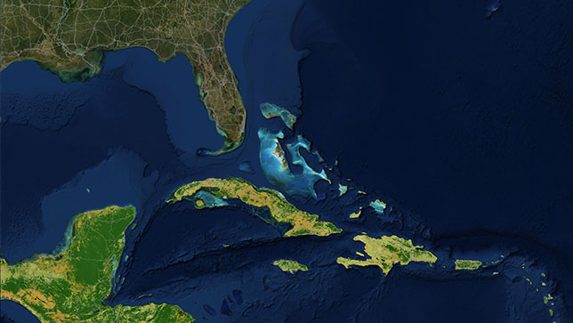 Zone de la mer des Caraïbes dont les îles apparaissent en jaune et en vert et zones de l’océan près de l’archipel des Keys en Floride apparaissant dans des tons de bleu plus lumineux que le reste de l’océan