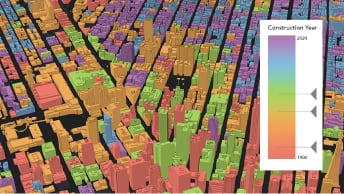 3D map of a metropolitan city showing multicolored buildings in red, yellow, and purple based on a gradient scale