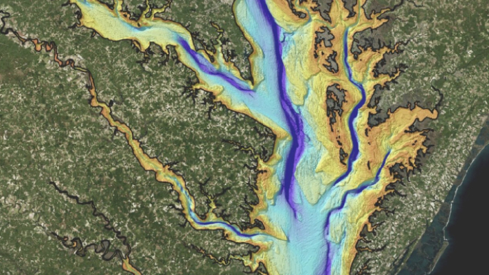 Aerial view of an elevation map with varying hues of green, yellow, and blue representing different elevations