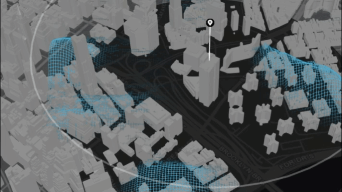 GIF del modelo de una ciudad 3D con edificios grises y redes azules en movimiento sobre áreas seleccionadas dentro de una región encerrada en un círculo