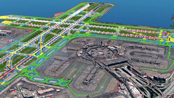 Luftansicht eines Flughafens neben einem blauen Gewässer, auf der die miteinander verbundenen Sensoren entlang der Landebahnen als Punkte dargestellt sind