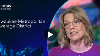 Video still for the Esri IMGIS conference featuring a photo of the female keynote speaker and graphics of buildings