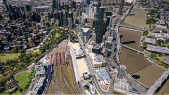 Digital twin’s aerial view of the city of Brisbane and its rail infrastructure, buildings, and green trees