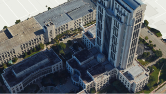 3D visualization of an aerial view of a group of four buildings surrounded by parking lots and green trees