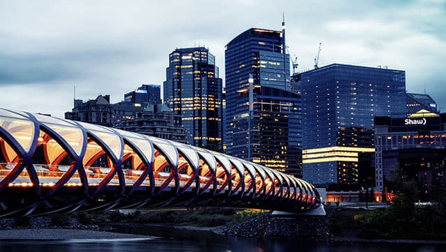 The Calgary, Alberta, skyline with a modern pedestrian bridge in the foreground