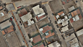 A satellite view of two blocks of industrial buildings