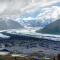 A glacier winding through a mountain range