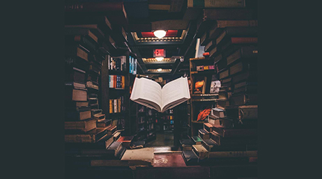 An open book floating in the center of a circular stack of books