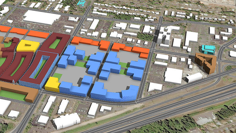 Uma vista aérea de vários blocos de edifícios modelados digitalmente, destacados em cores diferentes ao lado de uma ferrovia 