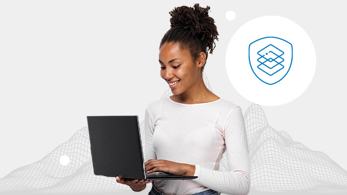 Lächelnde Person in weißem Oberteil, die stehend an einem Laptop arbeitet, vor einem grauen Hintergrund mit einem digitalen Gitternetz