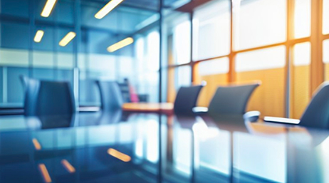 An empty conference table in a modern office in soft focus