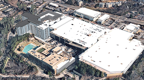 Aerial view of a 3D model of a large parking structure adjacent to a hospital building