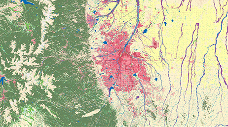 An aerial image of a wilderness area shaded in green, pink, and yellow with blue rivers winding through