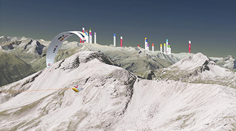 A parasailor flying over a steep mountain range covered in snow