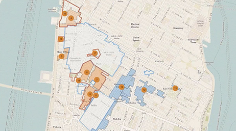 A map of a portion of lower Manhattan with blocks outlined in blue and orange overlaid with a play button 