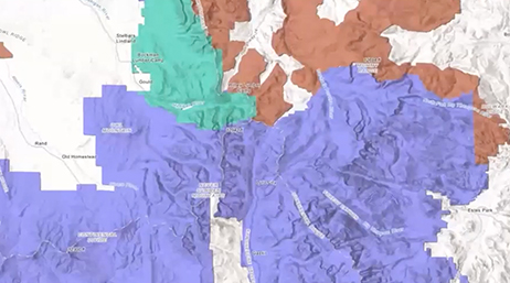 A black and white relief map with sections highlighted in purple, red, and turquoise overlaid with a play button