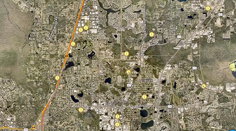 The view from a satellite with yellow dots pinpointing dispersed locations overlaid with a play button 