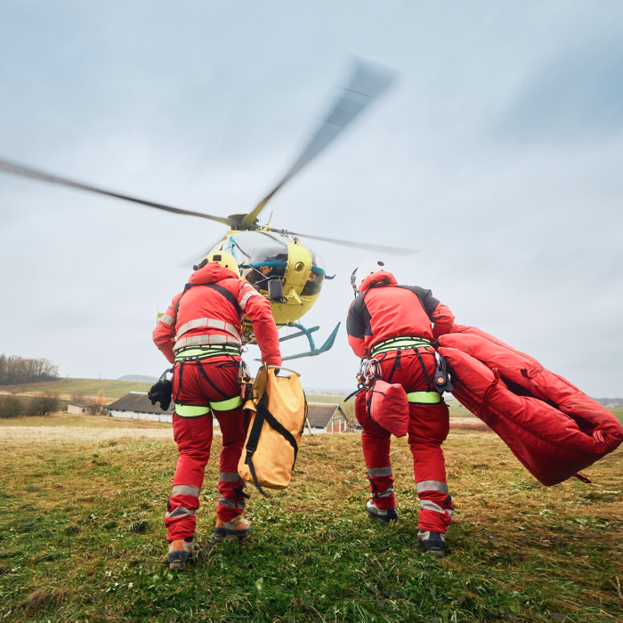 Fire rescue running toward a helicopter taking flight