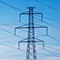 Multiple high-voltage power lines against a background of blue sky