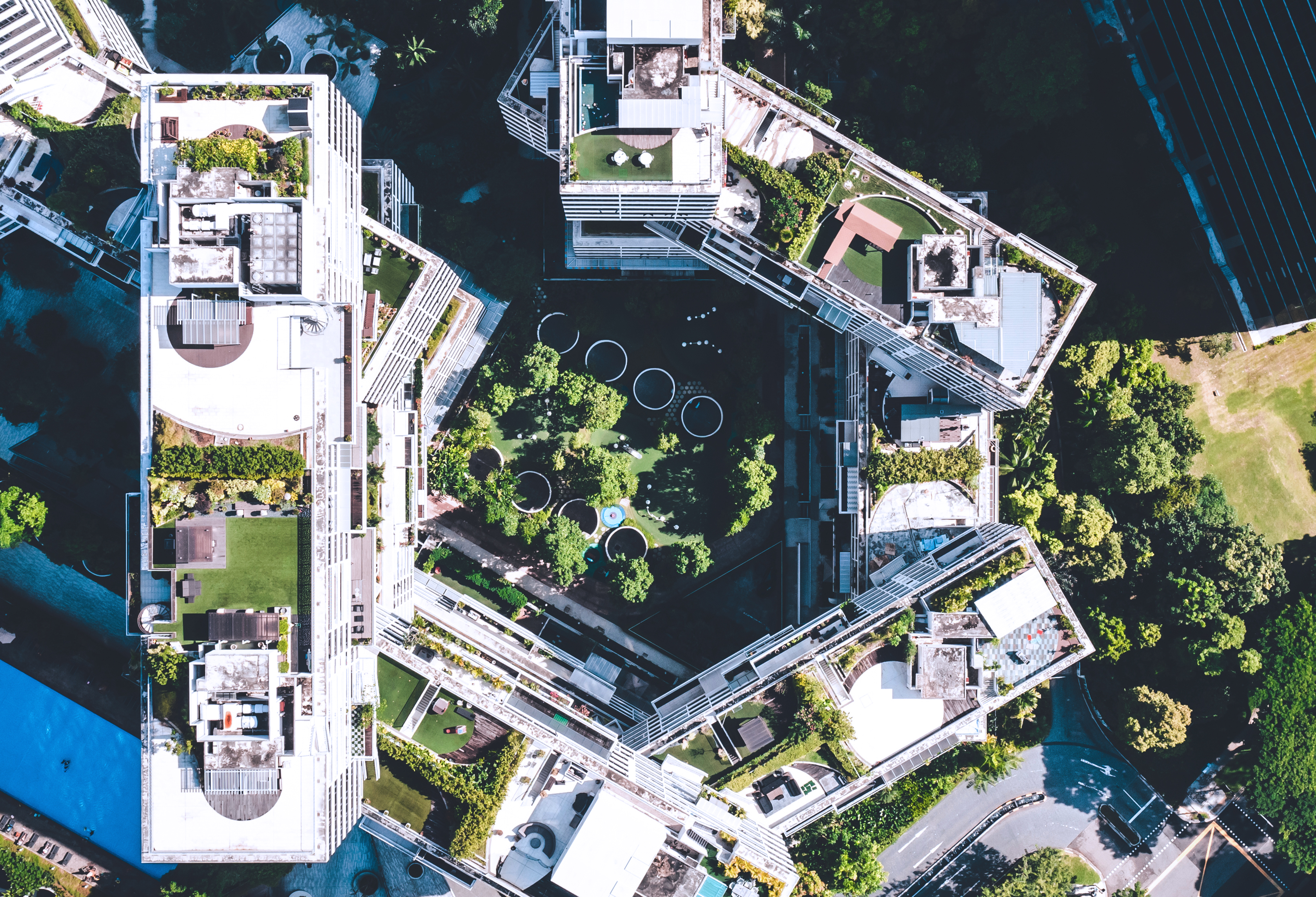 Aerial view of tall apartment buildings with green space in between them