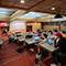 Students using laptops and sitting at desks in a large lecture hall