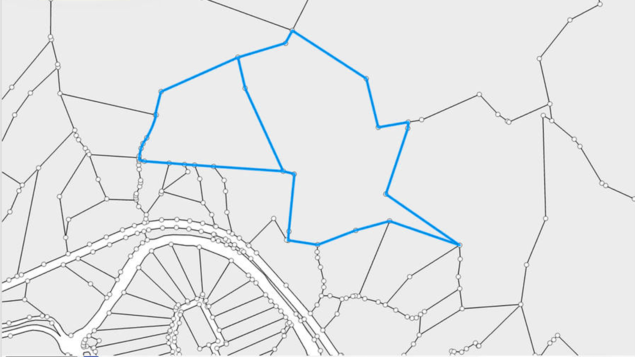 A map with a network of lines and nodes, with a large, irregular polygon highlighted in blue.